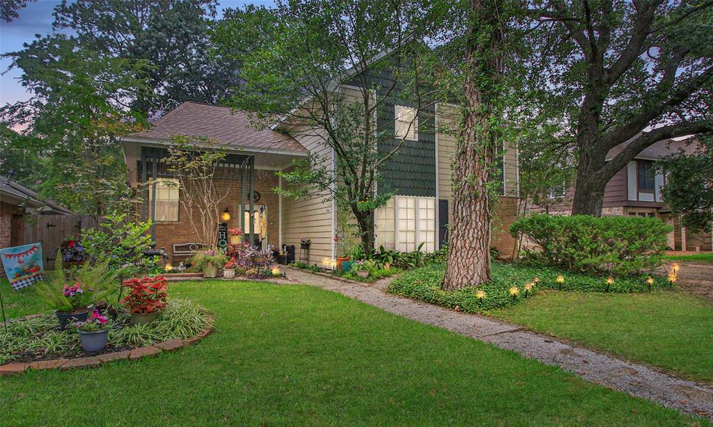 a view of a house with a yard and sitting area