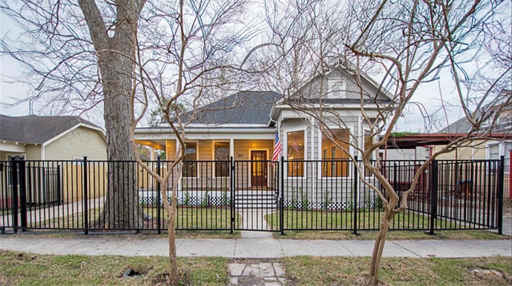 a front view of a house with iron fence