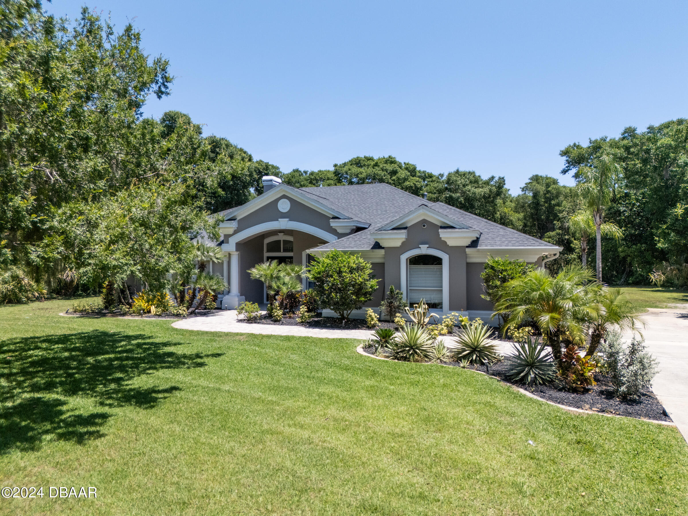 a front view of a house with garden