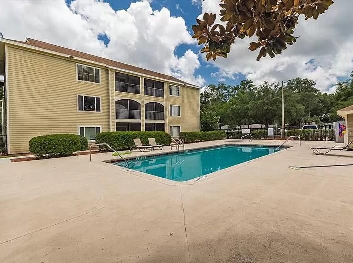 a view of a house with a swimming pool and a yard