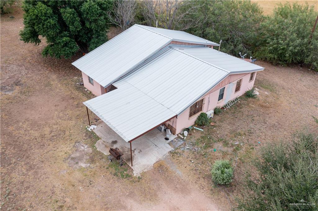 an aerial view of a house with yard and trampoline