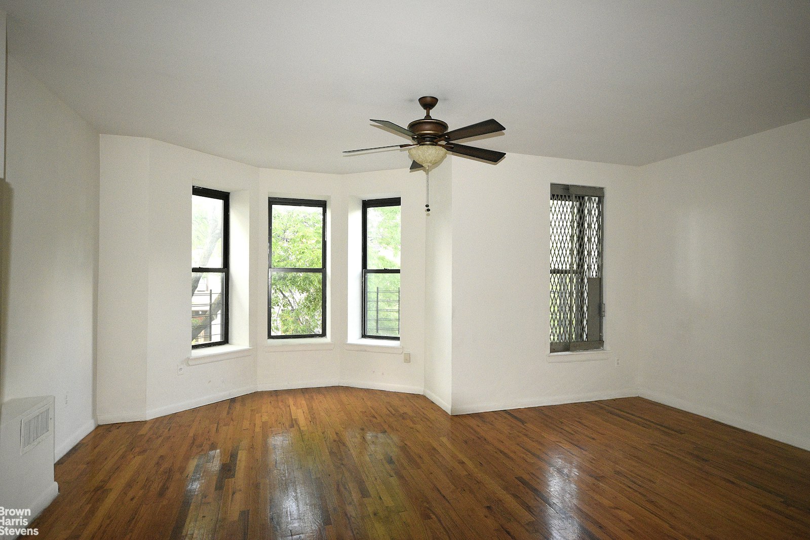 a view of a bedroom with a bed and a window