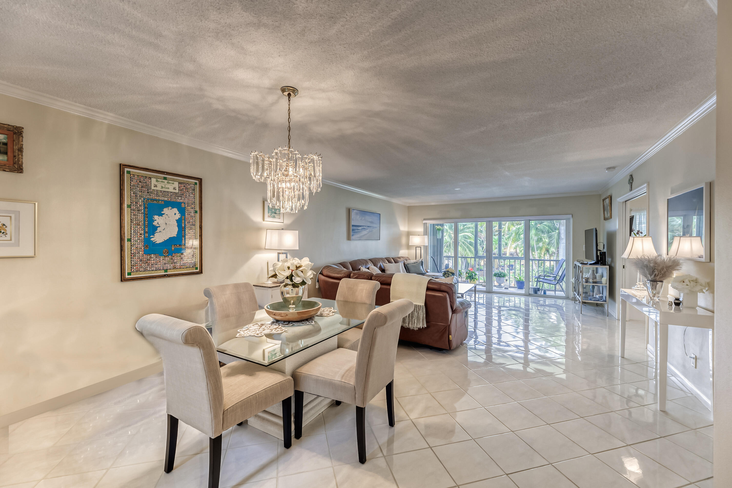 a dining room with furniture a chandelier and window