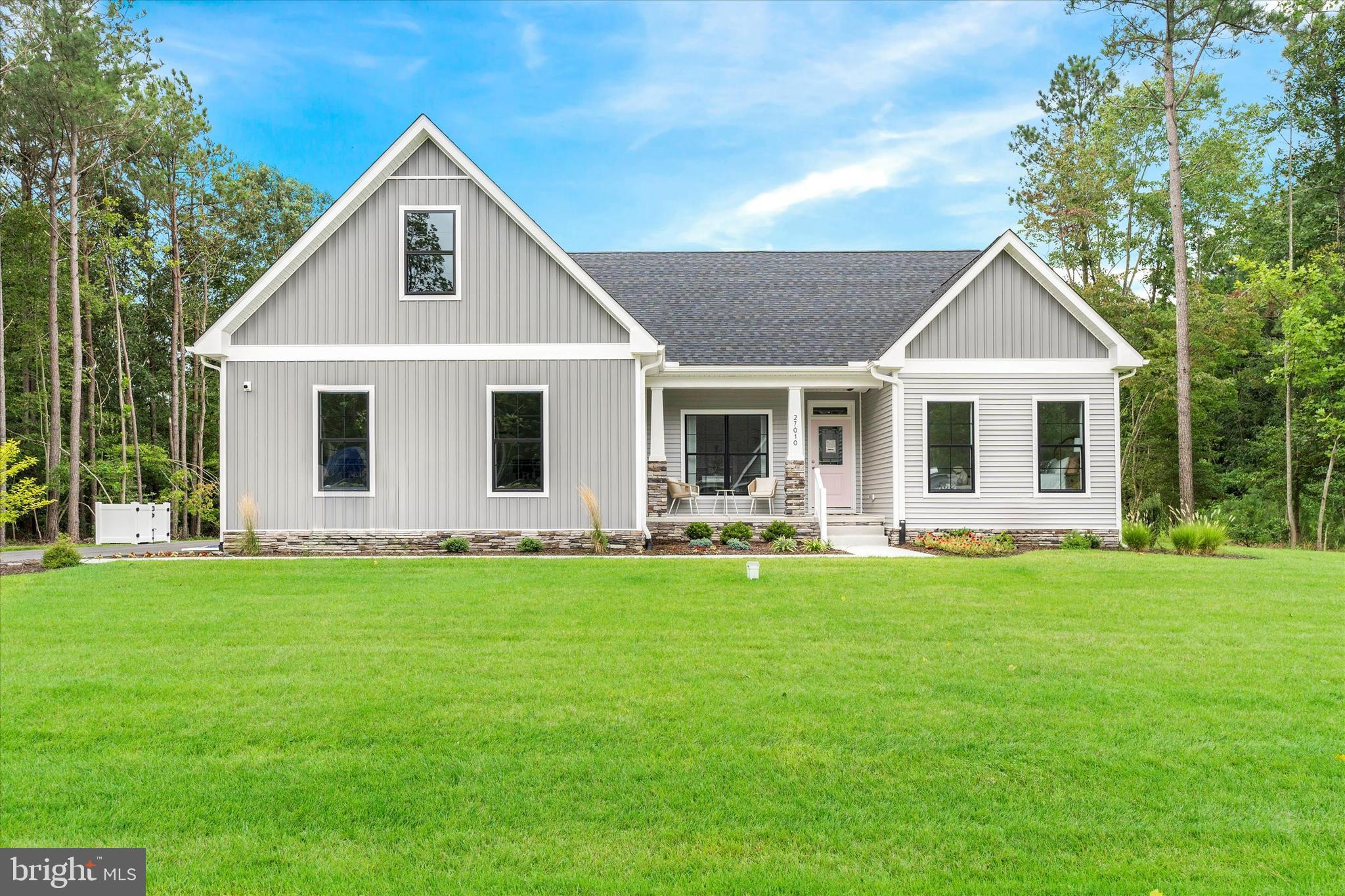 a view of a house with a yard and front view of house