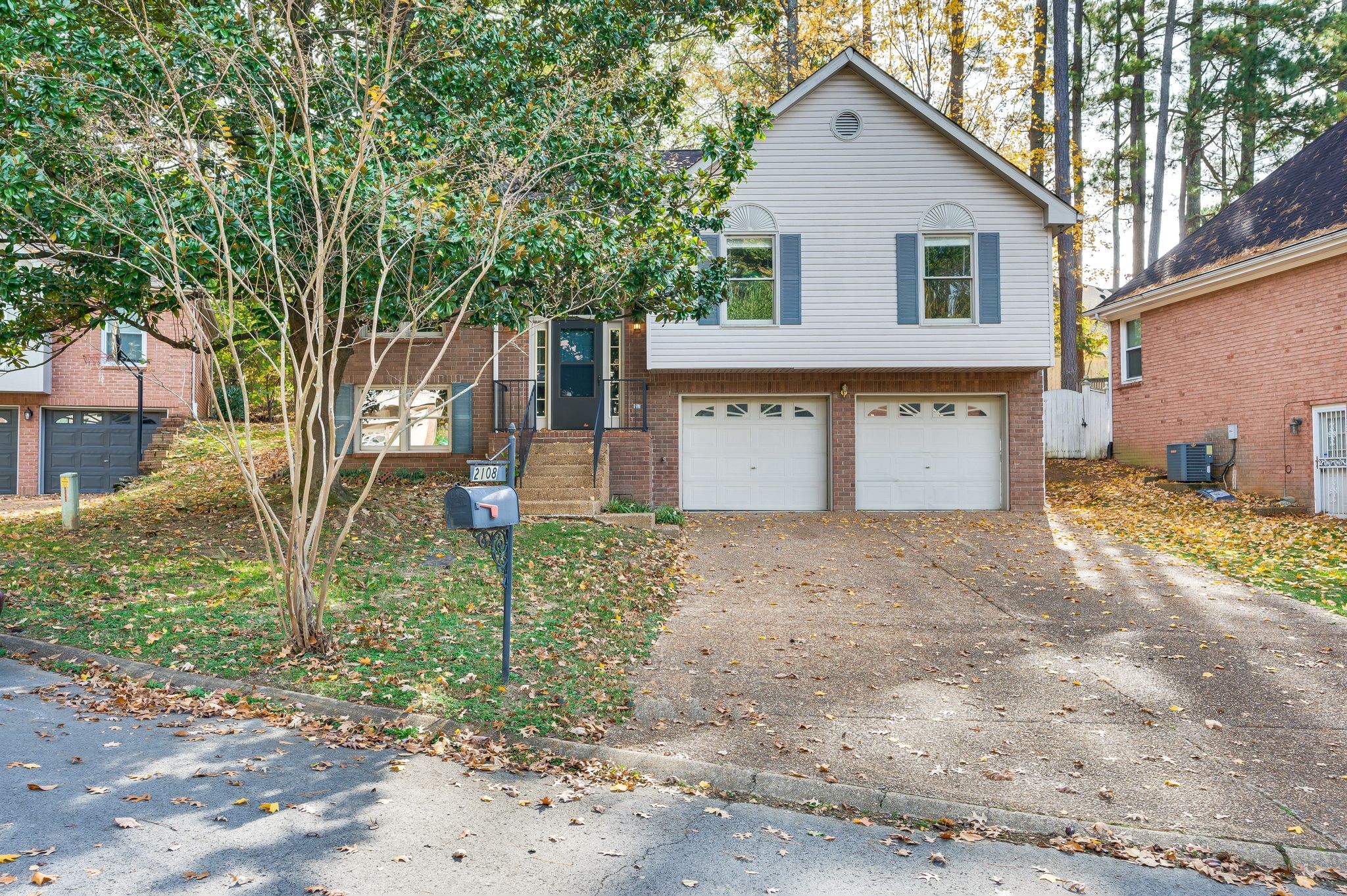 a view of a house with a yard and tree