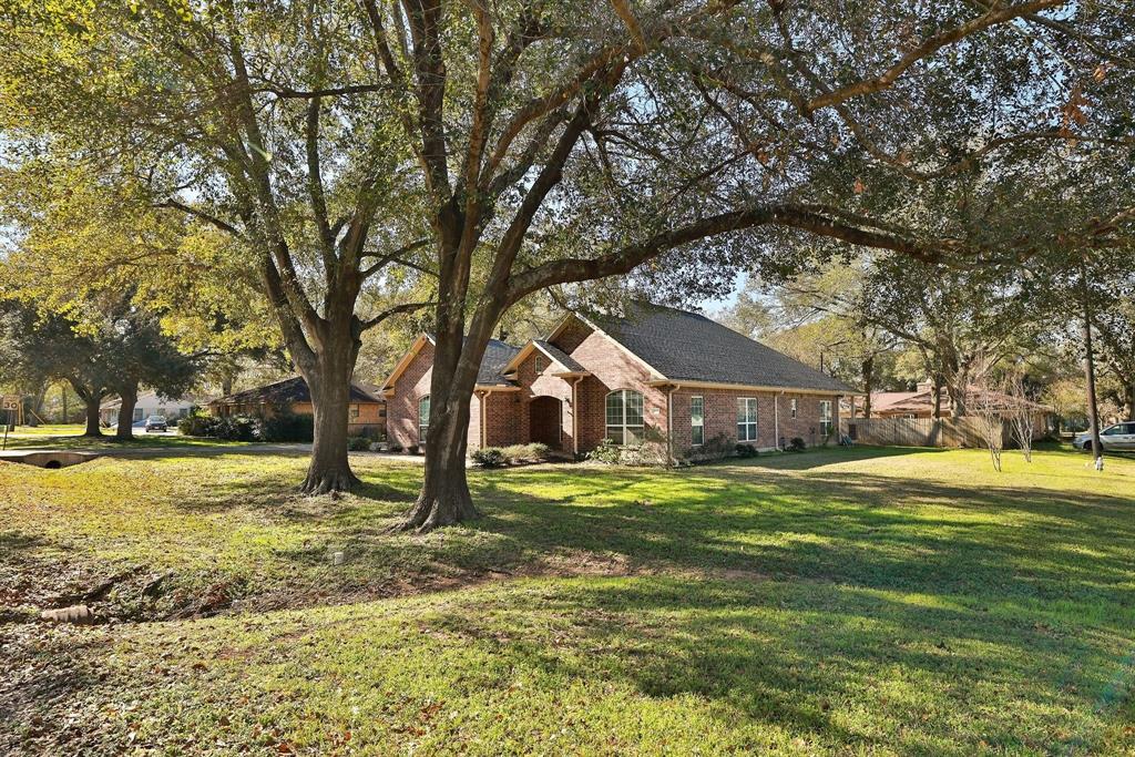 Situated on a third-acre corner lot with mature shade trees