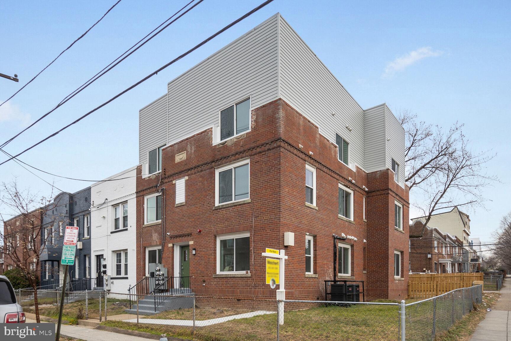 a view of a brick building next to a yard