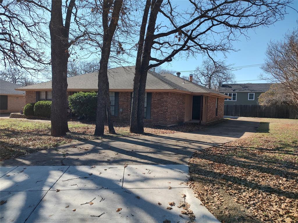 a view of a house with a yard and tree s