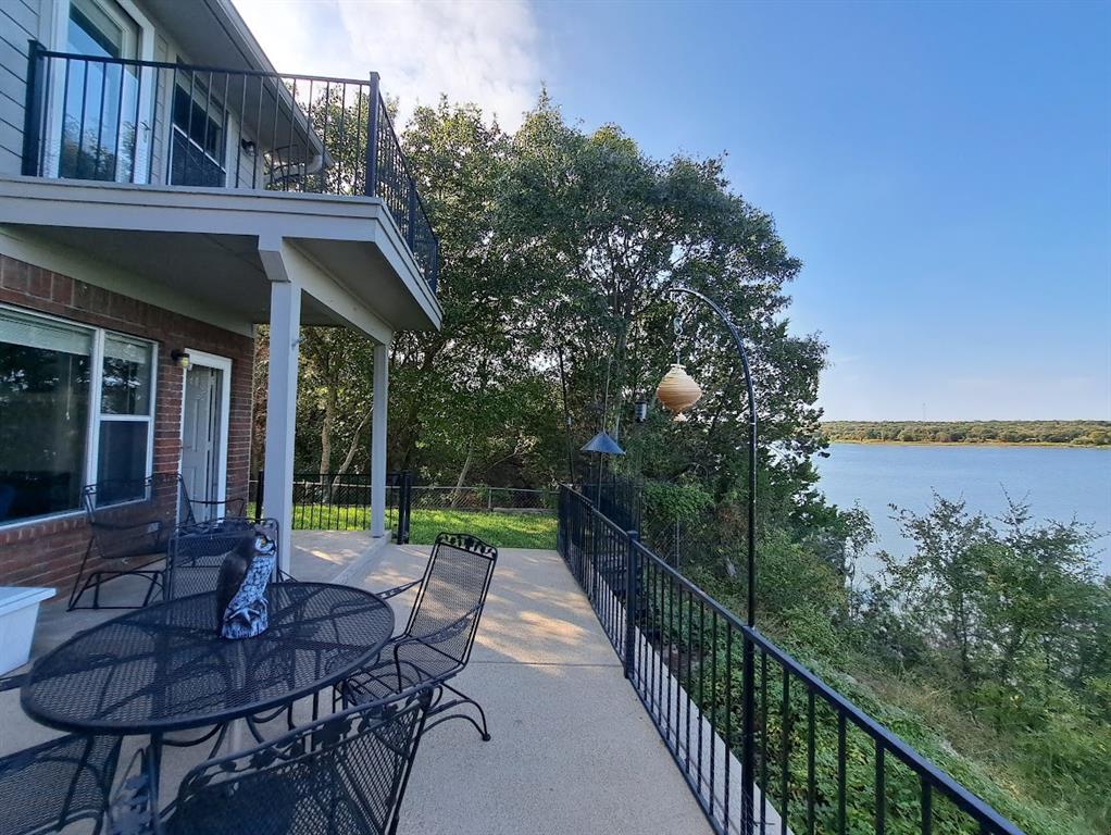 a view of house with backyard outdoor seating and hardwood