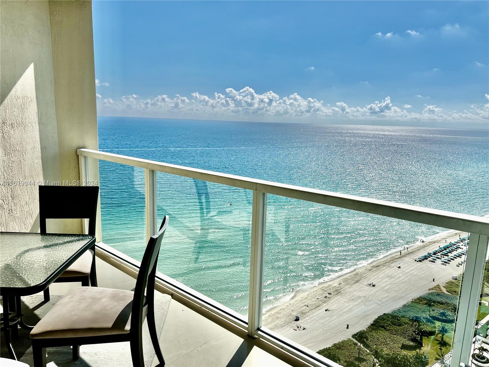 a view of a balcony with an ocean view