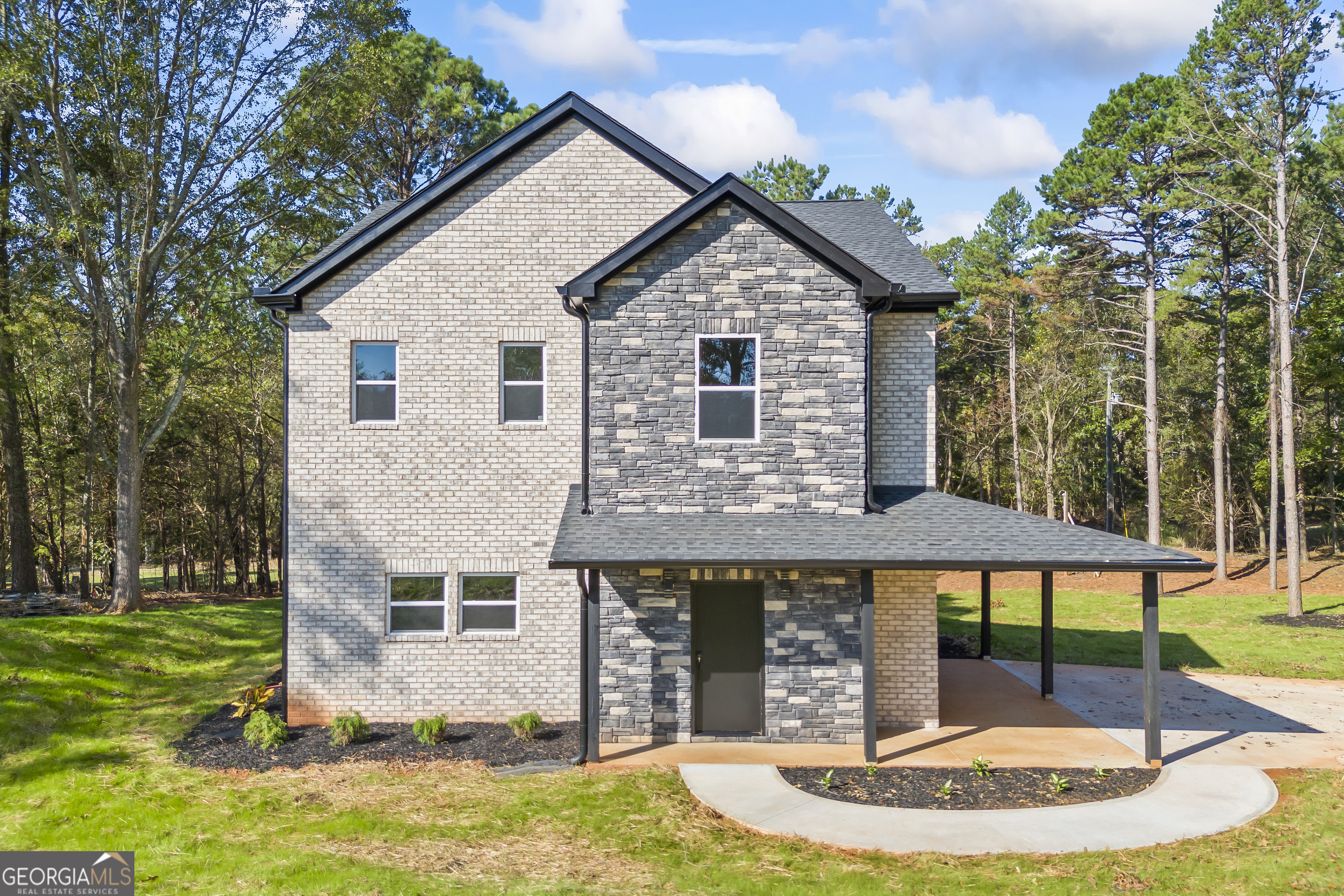 a view of a house with backyard porch and sitting area