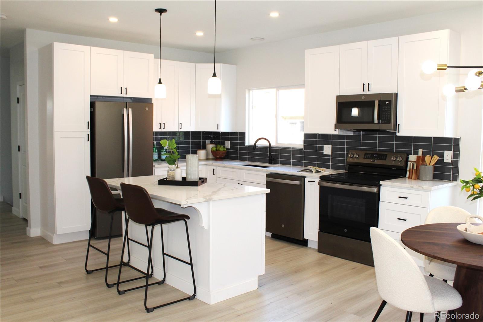 a kitchen with a sink stove and refrigerator