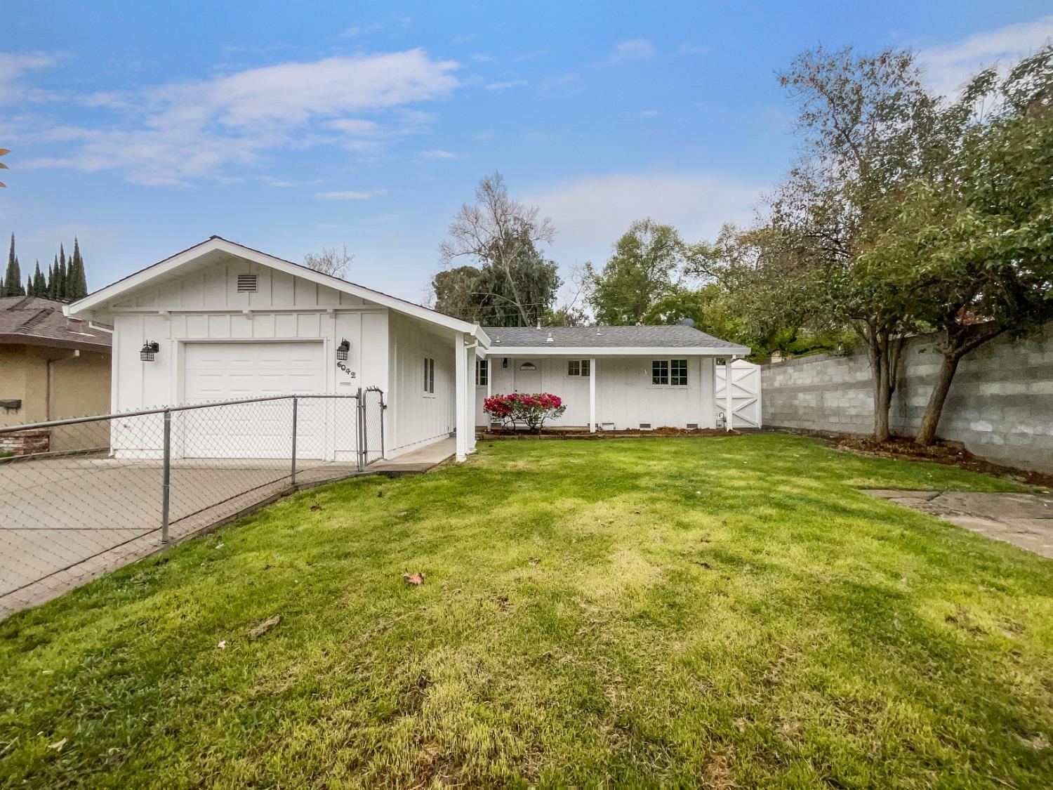 a view of house with backyard and entertaining space