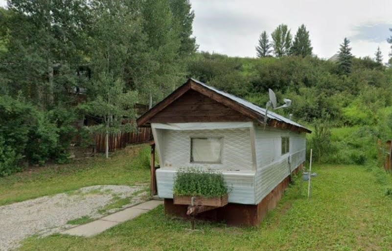 View of side of home with a yard