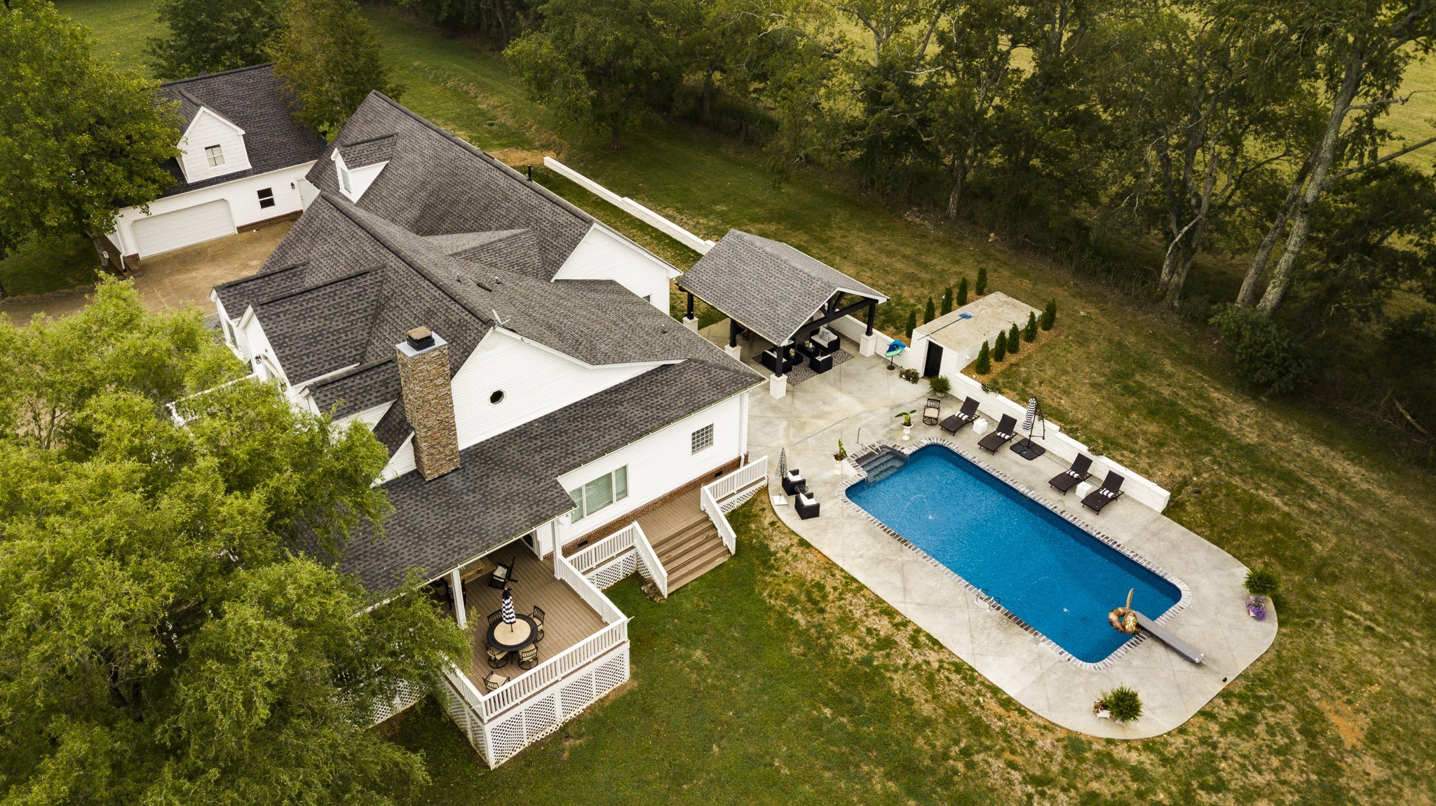 an aerial view of house with yard swimming pool and outdoor seating