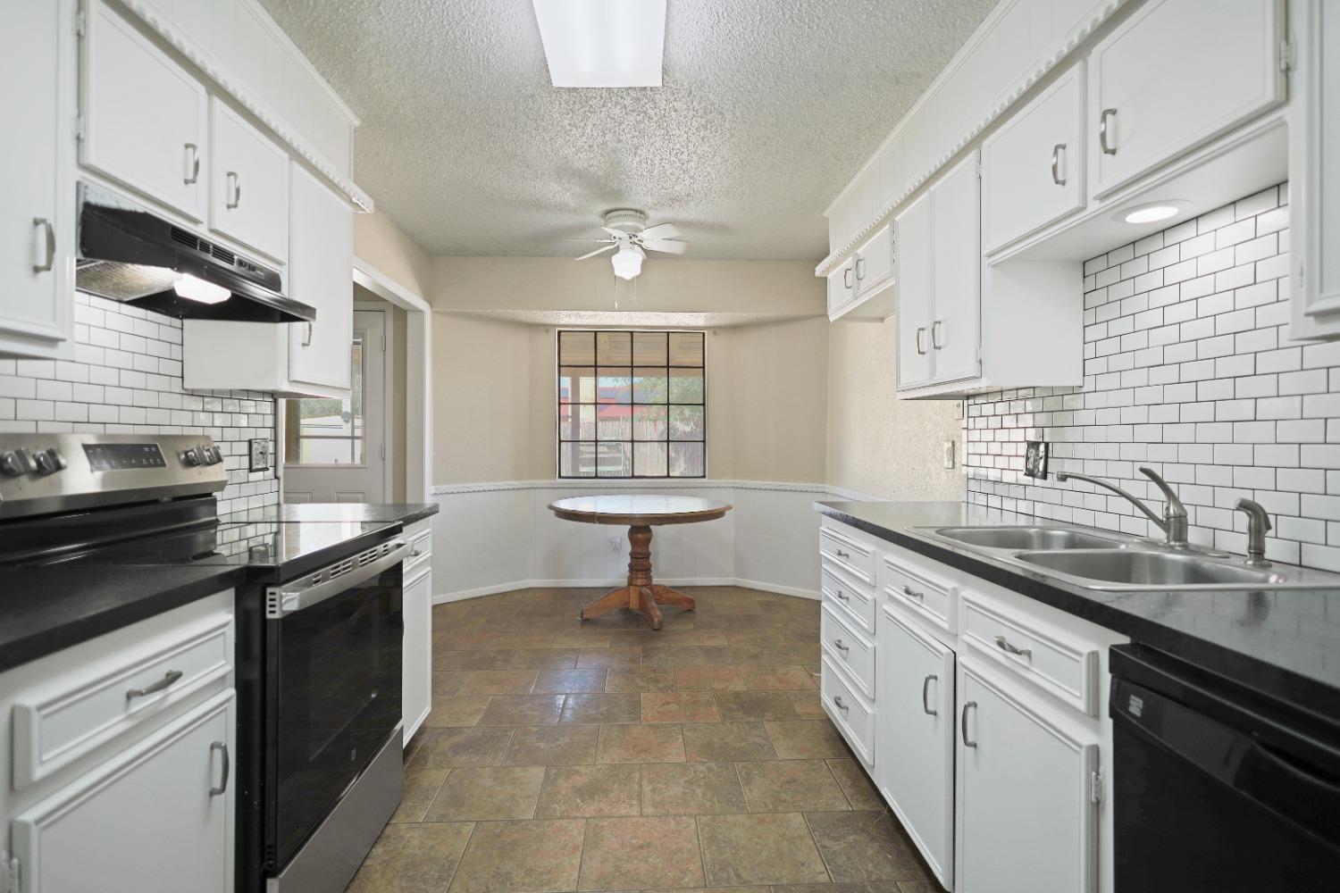 a kitchen with a sink stove and cabinets