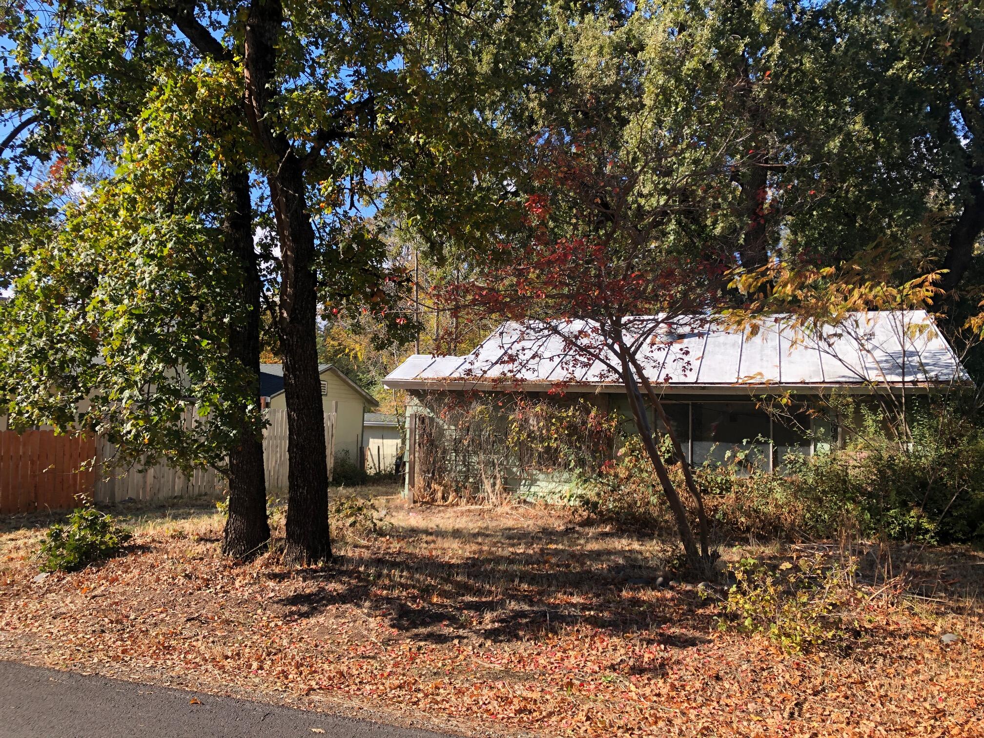 a view of a tree in front of a house