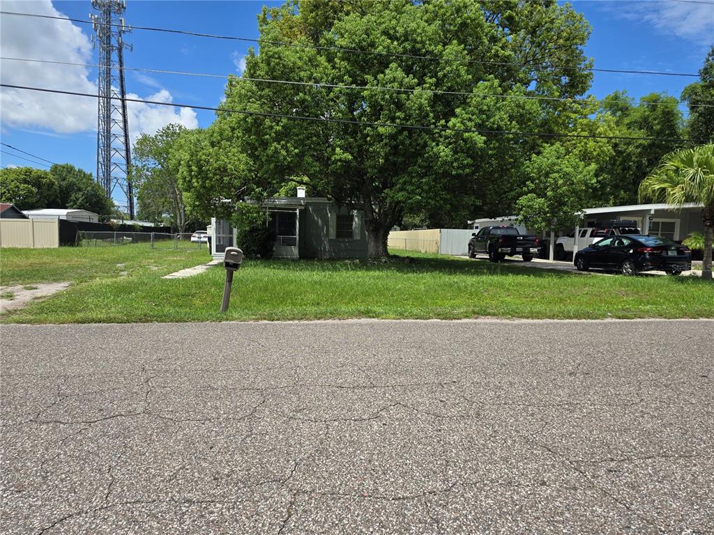 a front view of a house with a yard and trees