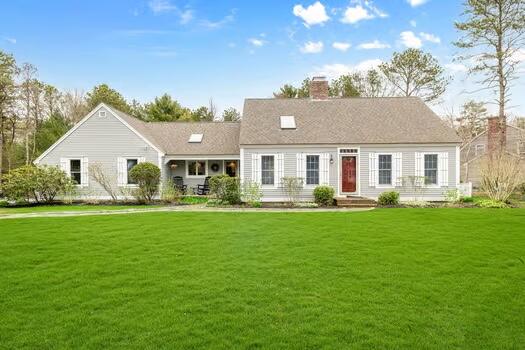 a front view of a house with a garden