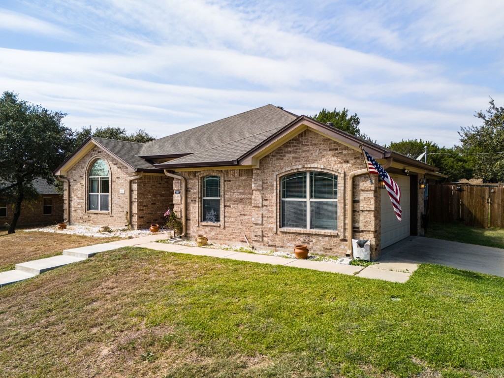 a front view of house with yard outdoor seating and barbeque oven