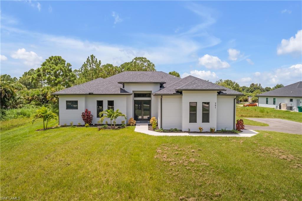 a front view of house with yard outdoor seating and barbeque oven