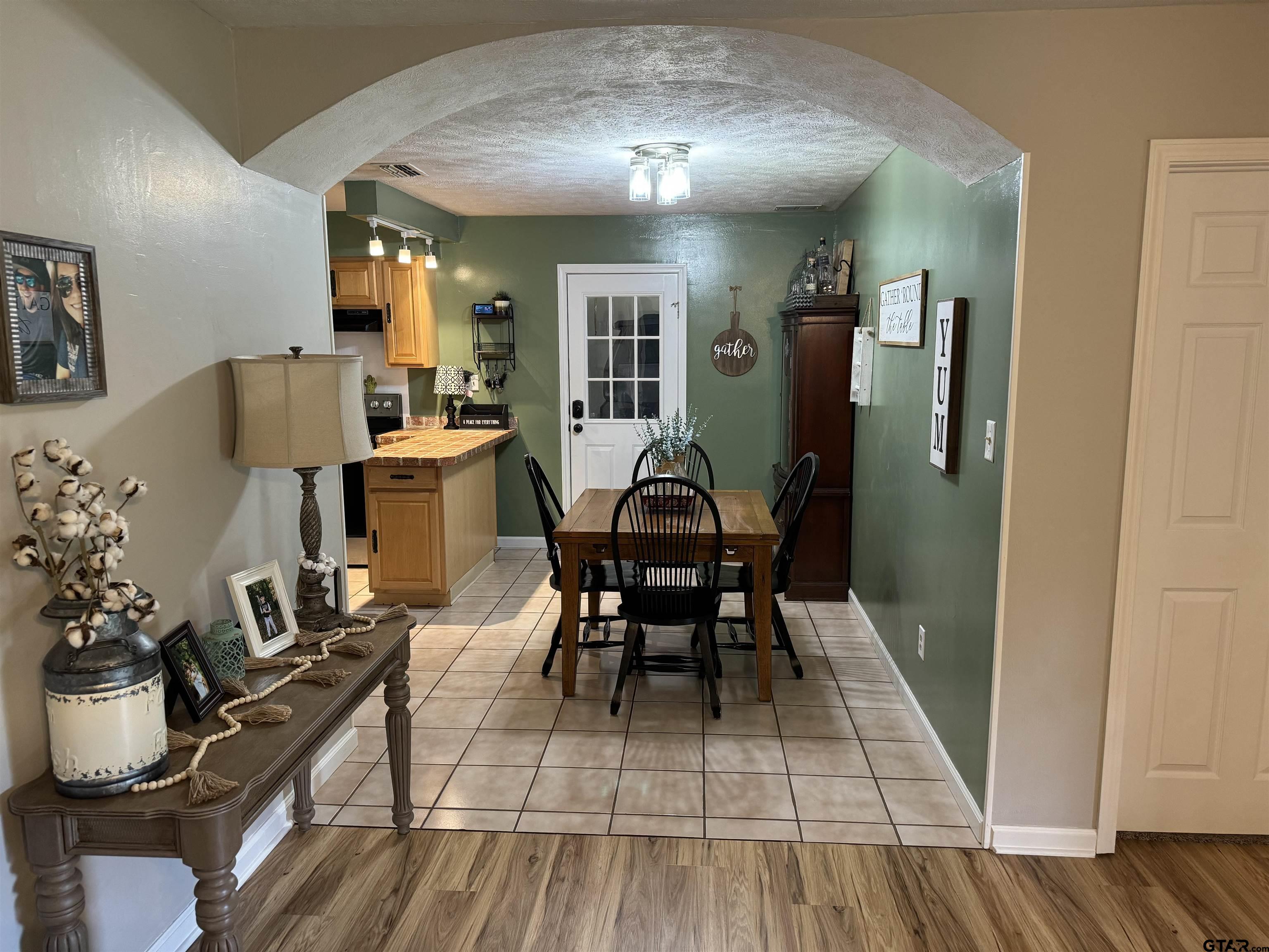 a dining room with furniture and wooden floor