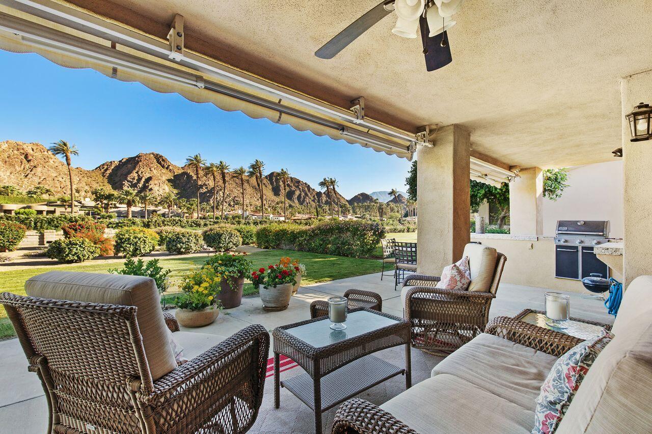 a outdoor living space with furniture and a flat screen tv