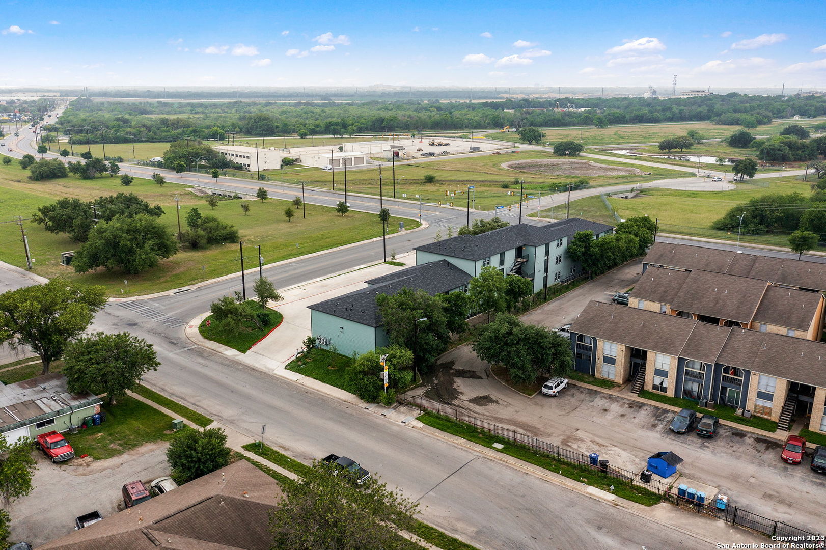 an aerial view of ocean with residential house and outdoor space