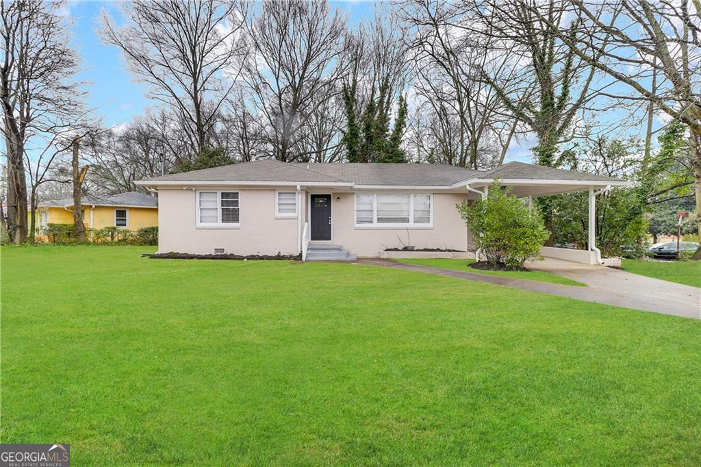 a front view of house with yard and green space