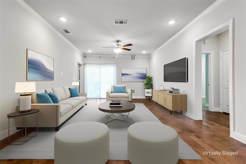 a living room with furniture a flat screen tv and a chandelier