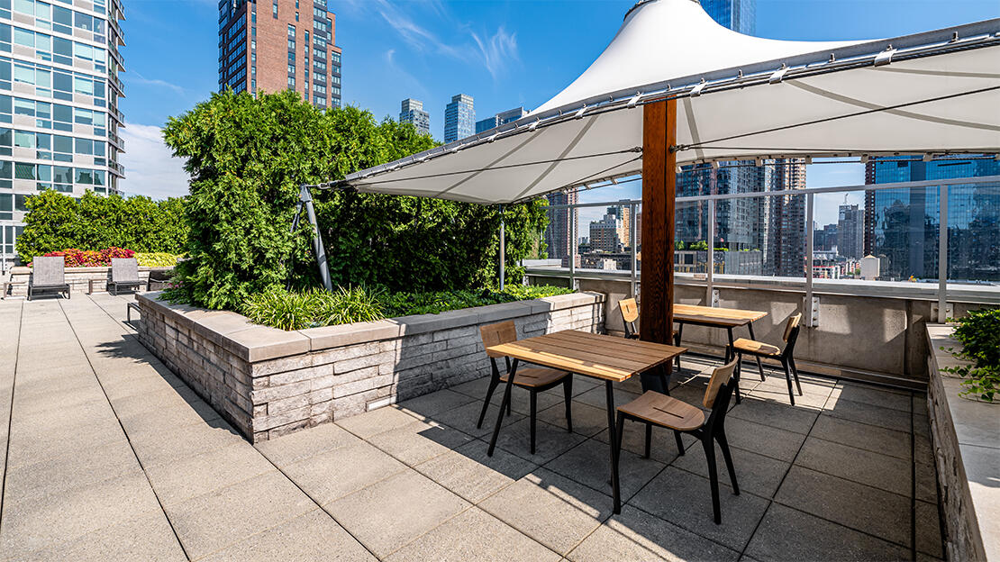 a view of patio with a table and chairs under an umbrella