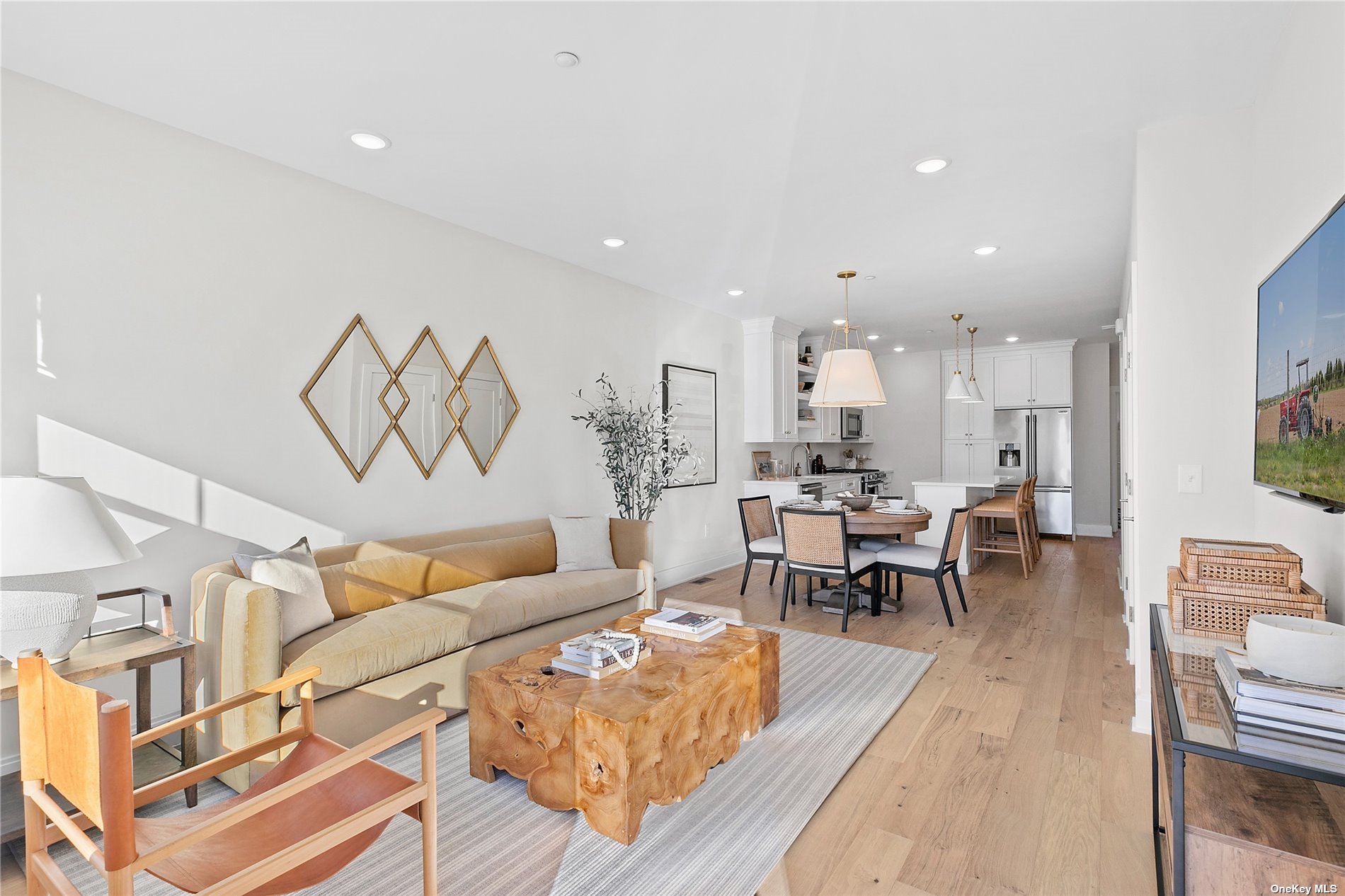 a living room with furniture kitchen view and a dining table