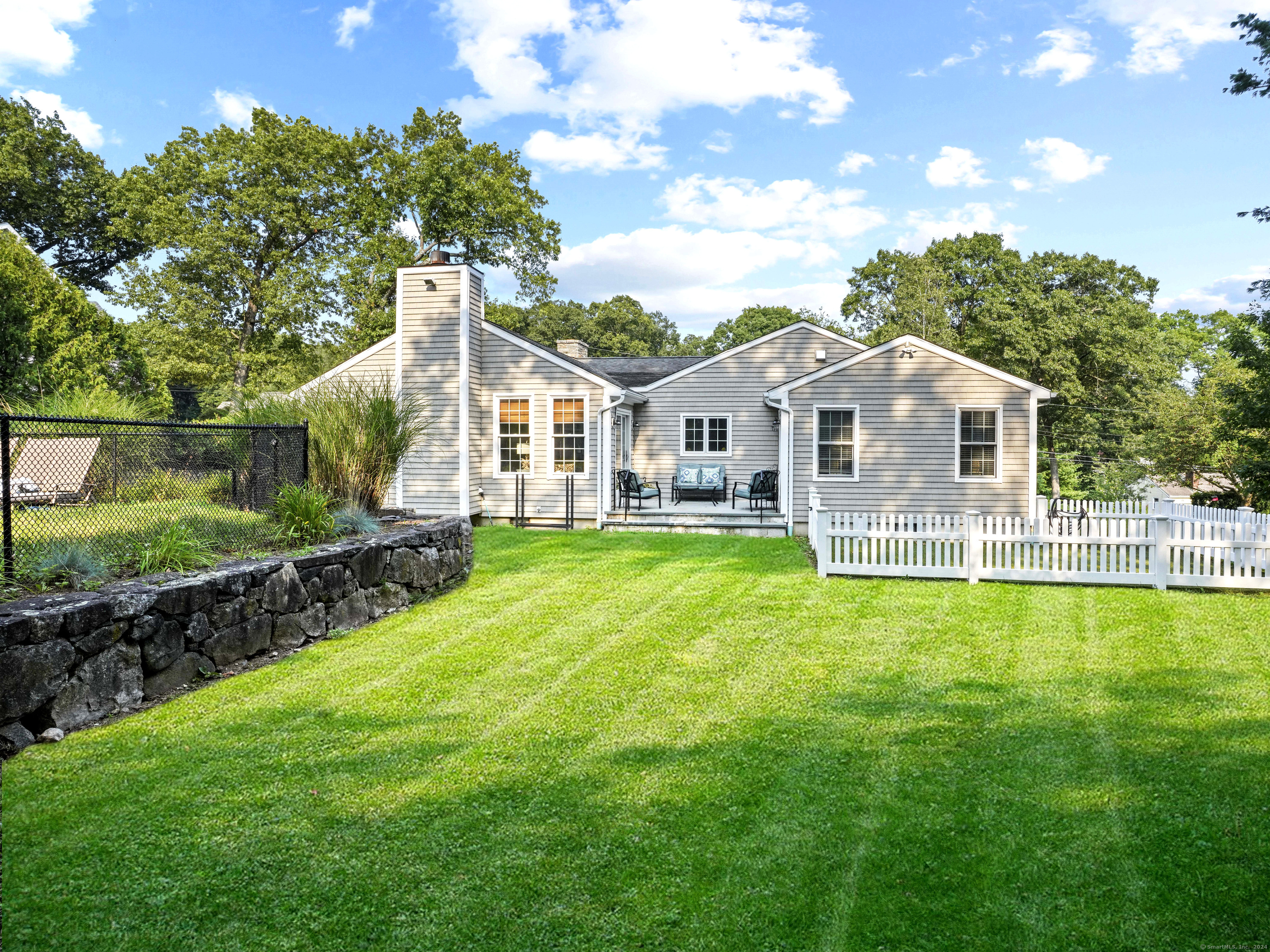 a front view of a house with a yard table and chairs