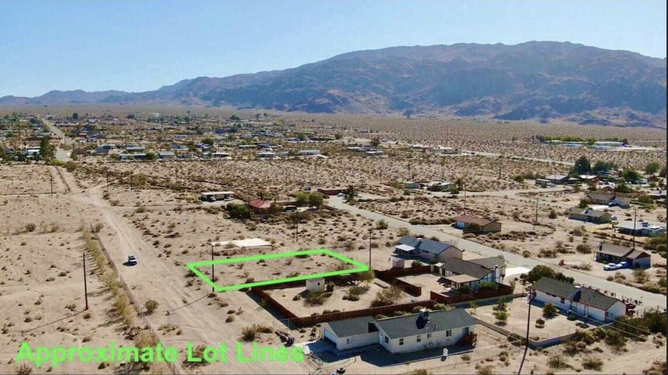 an aerial view of residential house and sandy dunes