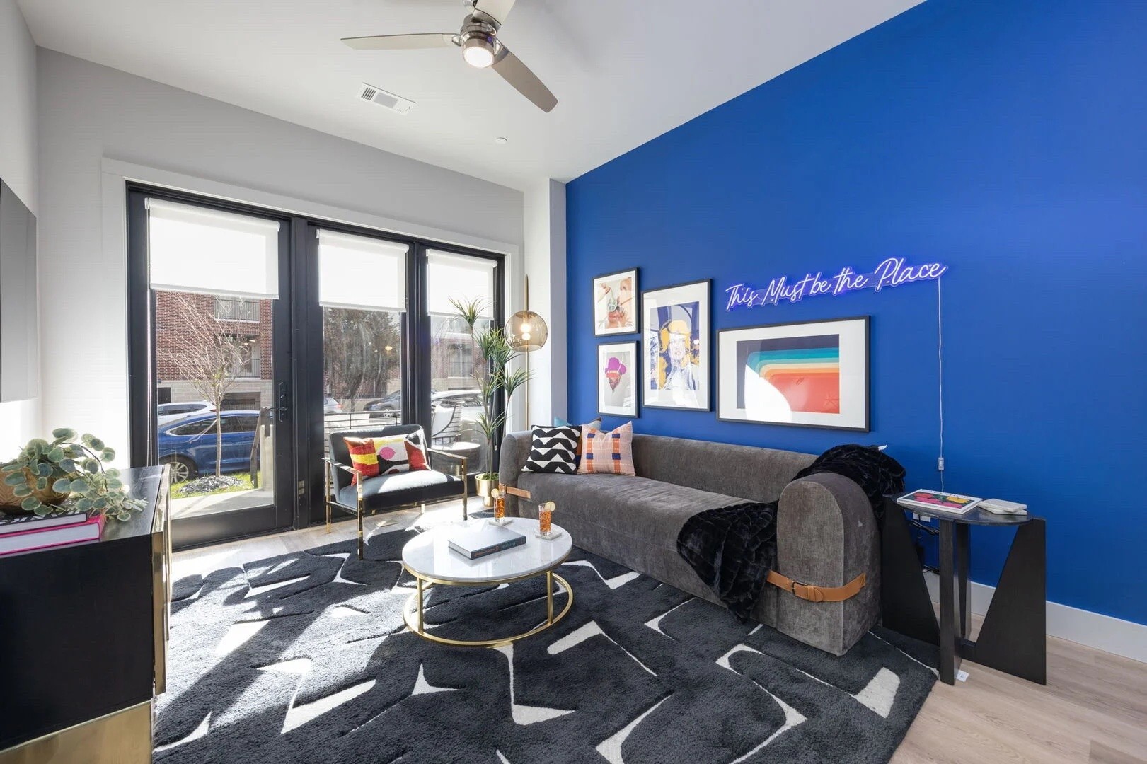 a living room with furniture and a floor to ceiling window