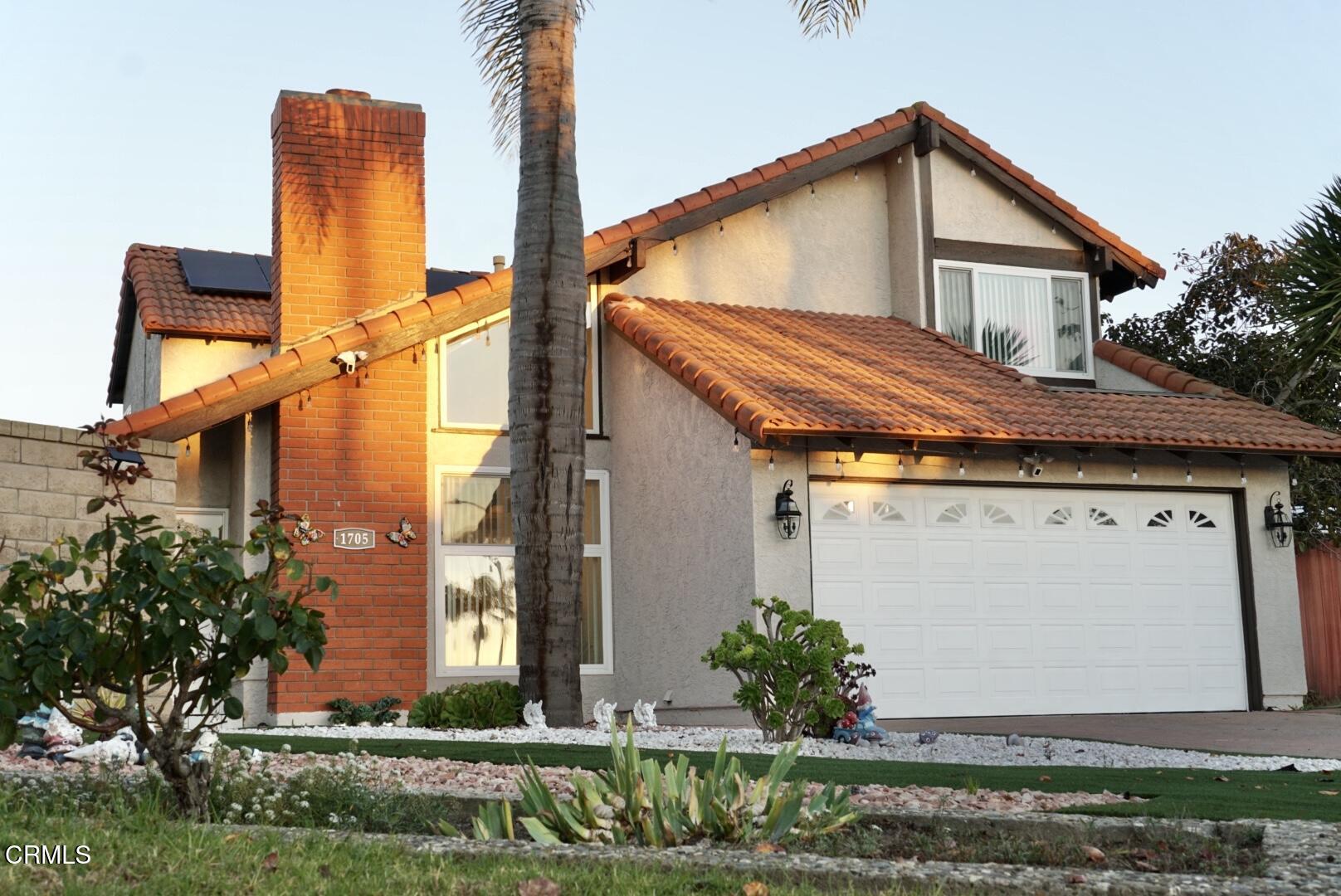 a view of a house with a yard and plants