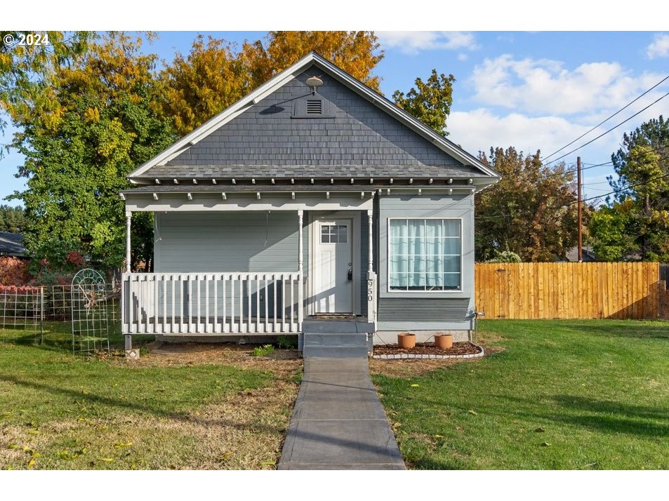 a front view of a house with a garden and deck