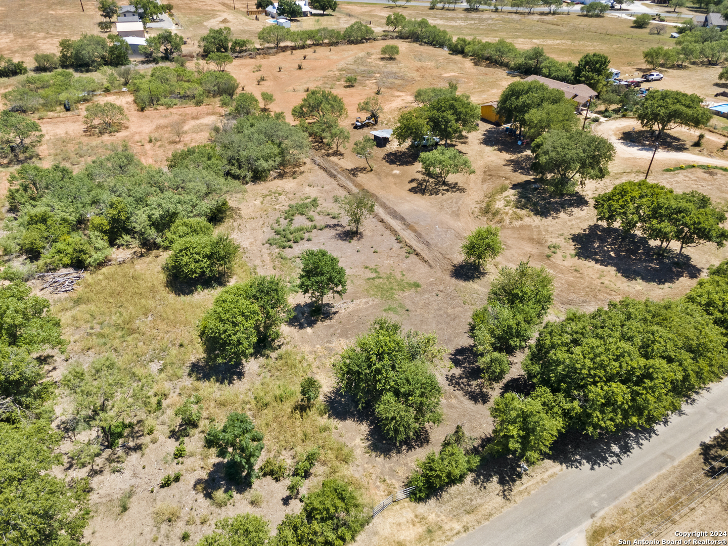 an aerial view of a houses with yard