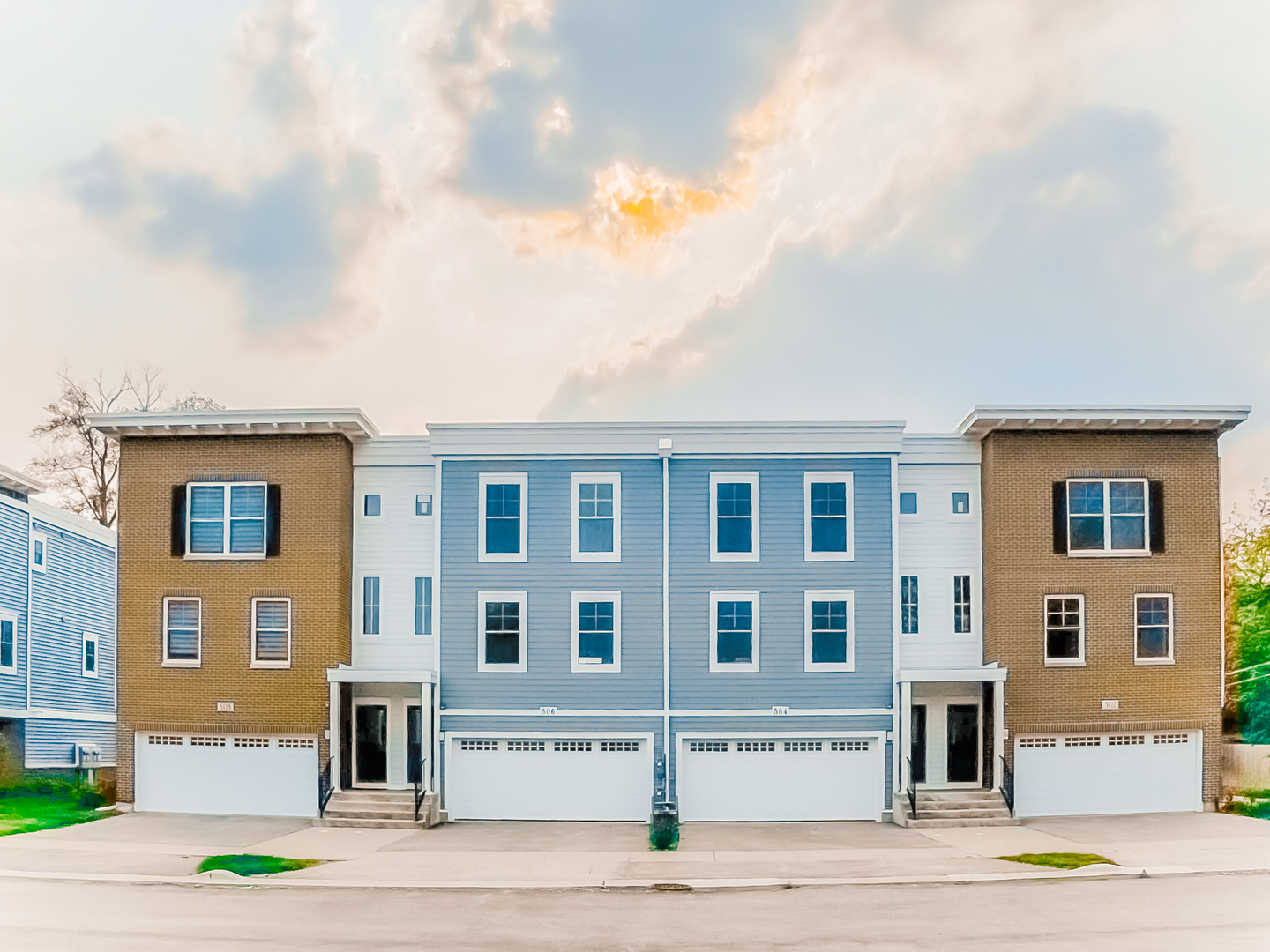 a front view of residential houses with yard