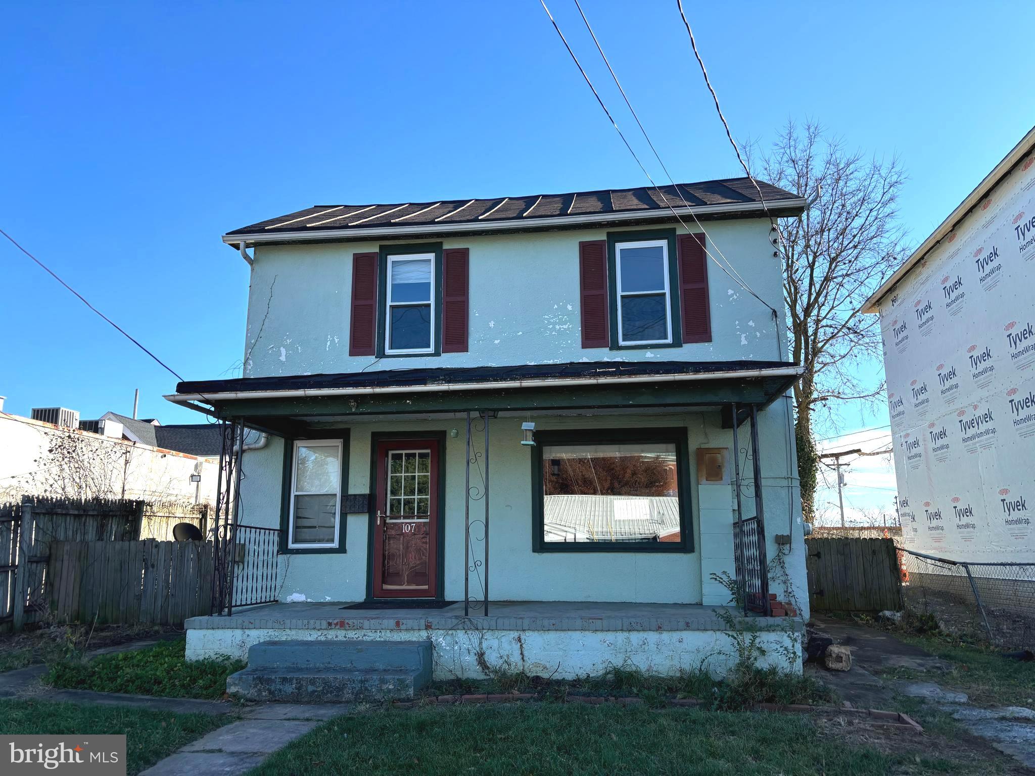 a view of brick house with a small yard