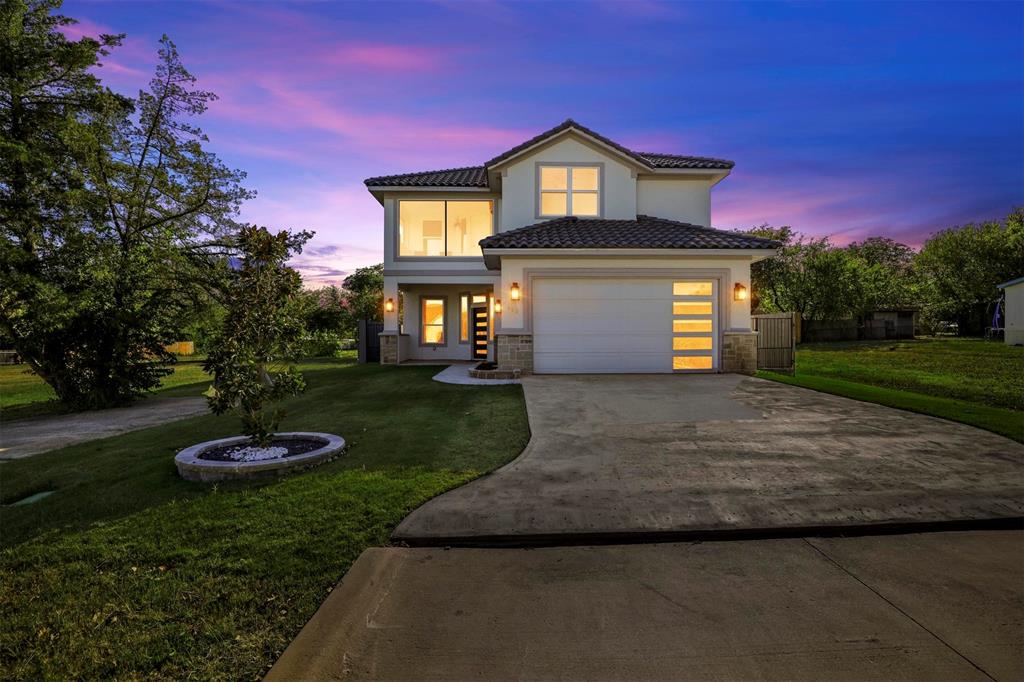 a front view of a house with a yard and garage