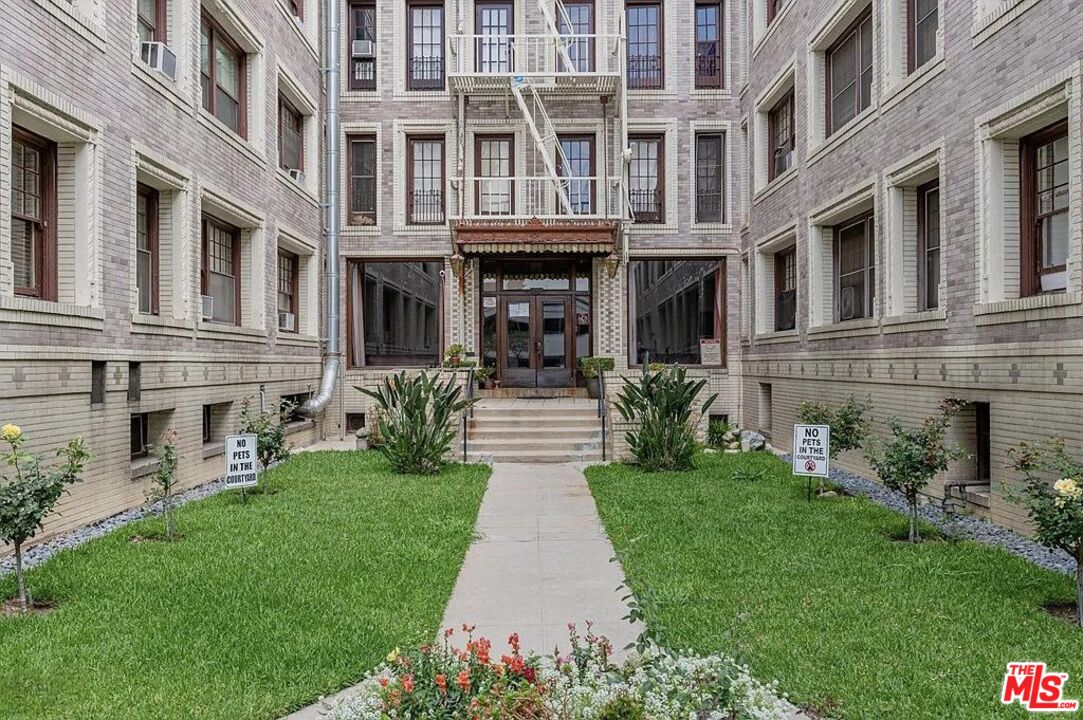 a front view of a building with garden