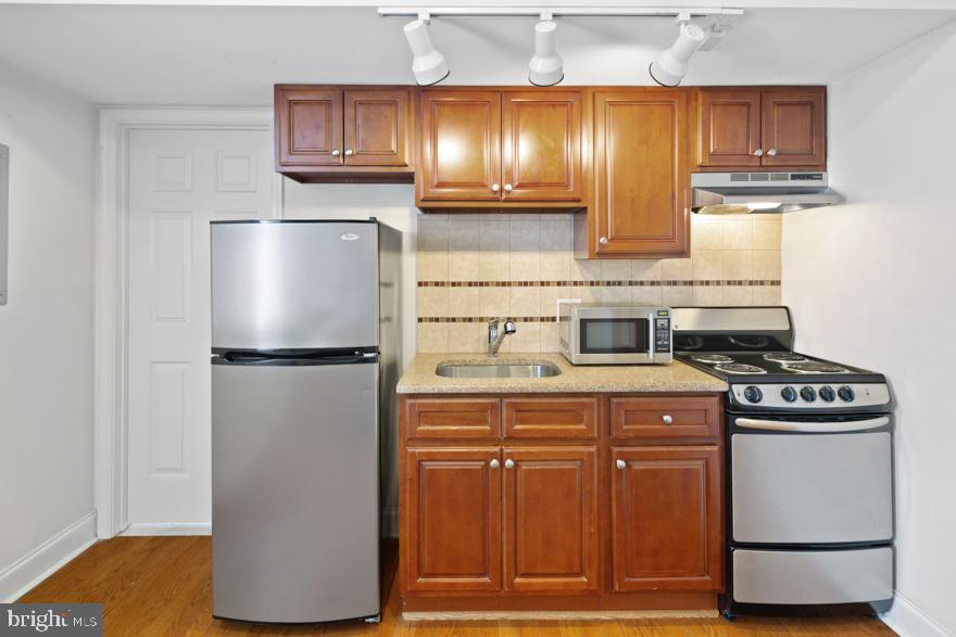 a kitchen with a refrigerator and a stove