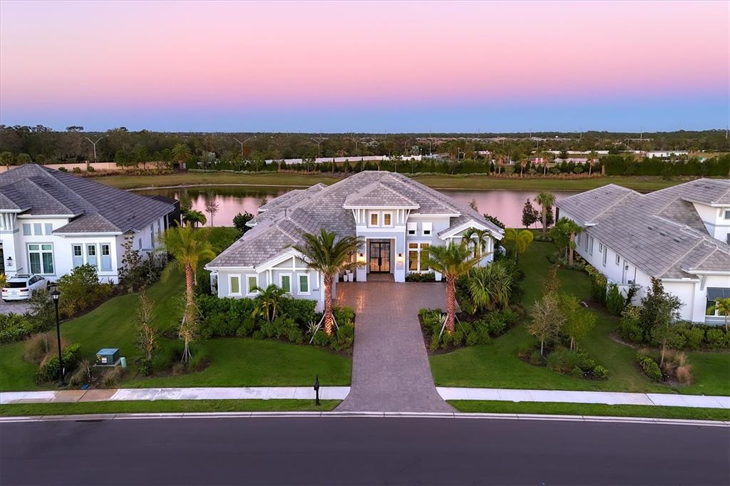 an aerial view of residential houses with outdoor space and ocean view