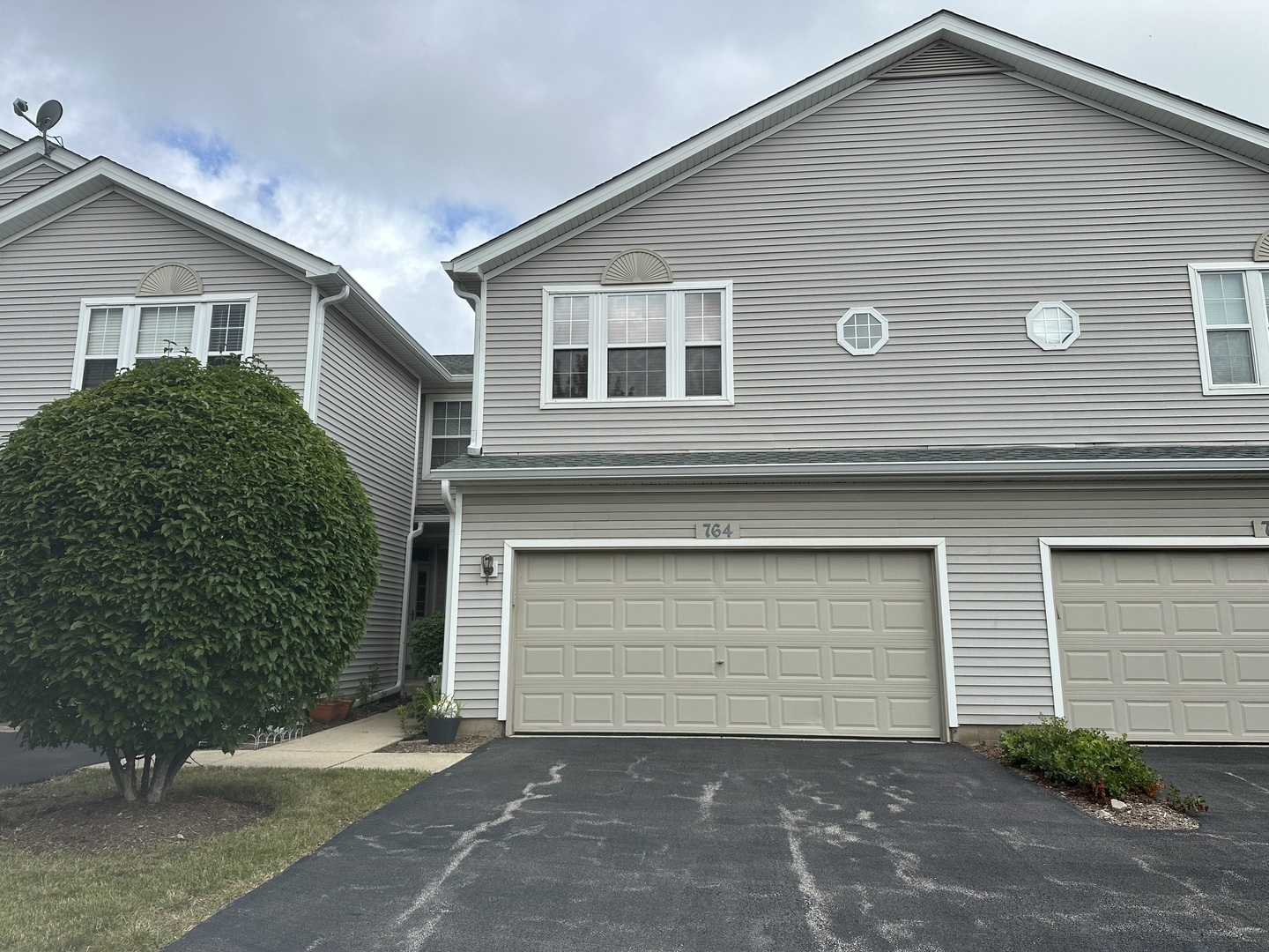 a front view of a house with a garage