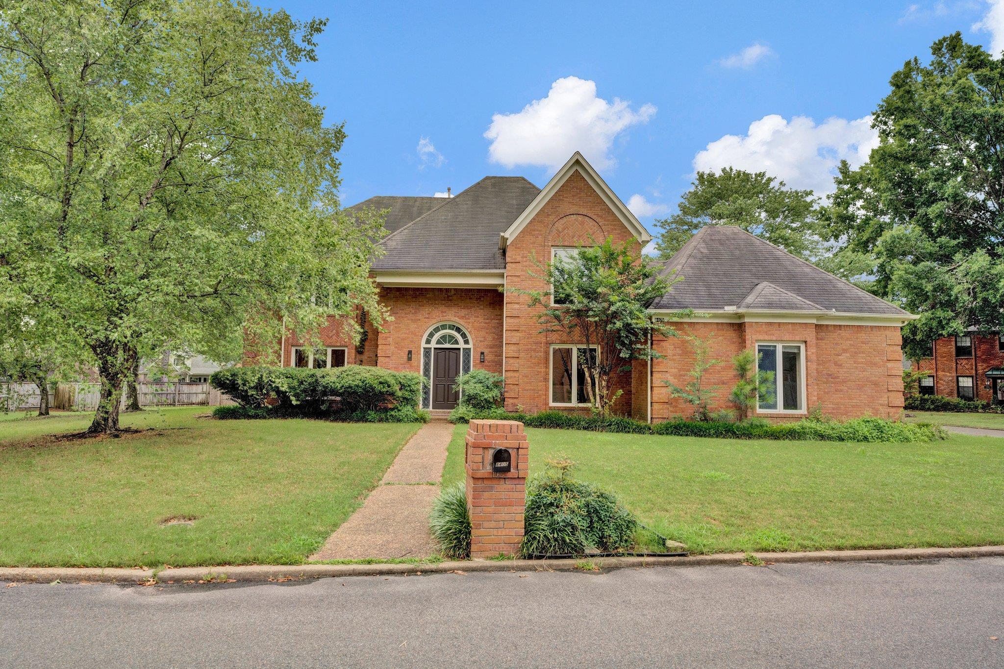 a front view of a house with garden