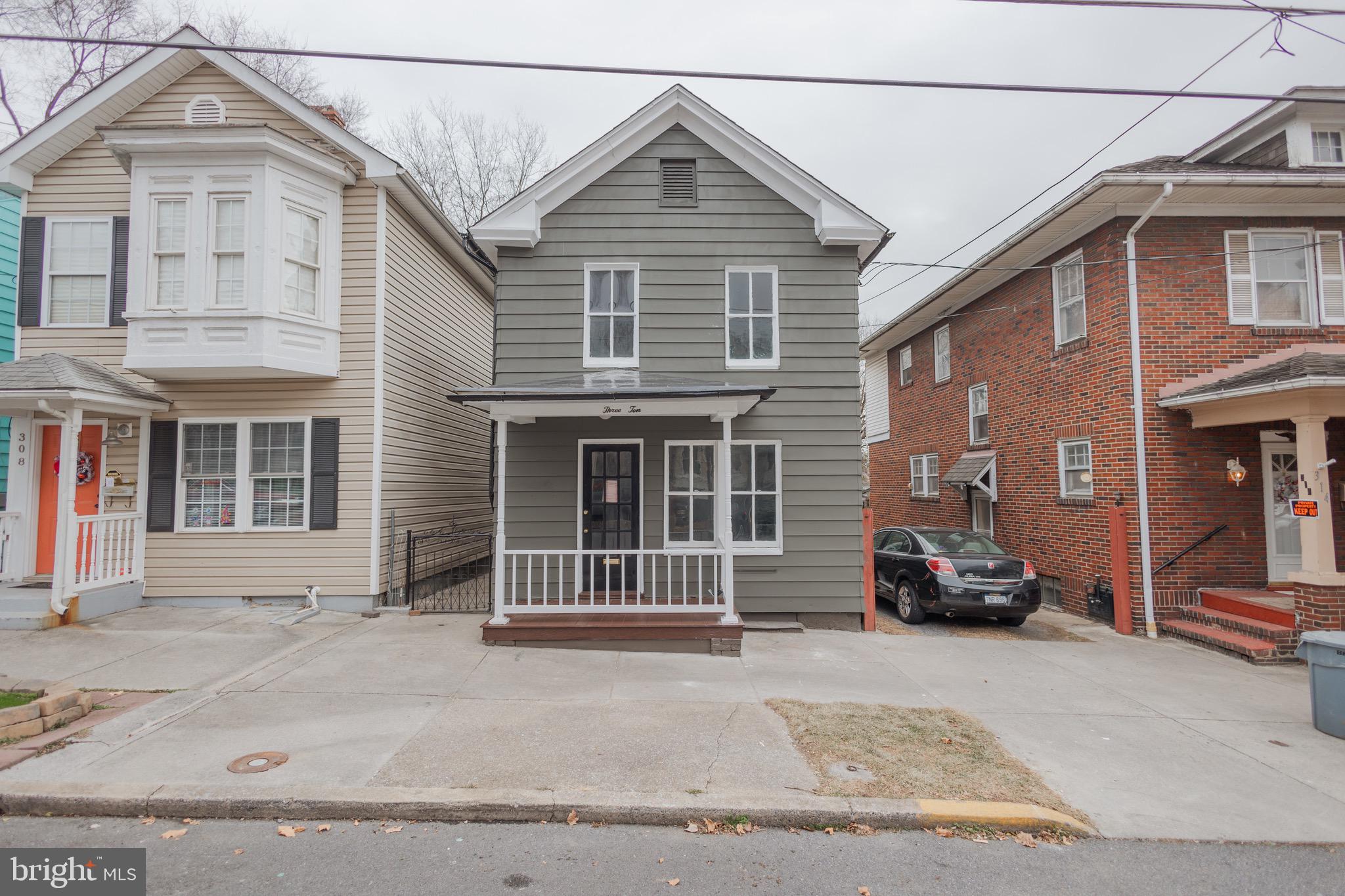 a view of a house with a large space and a car parked front of it