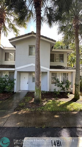 a front view of a house with yard