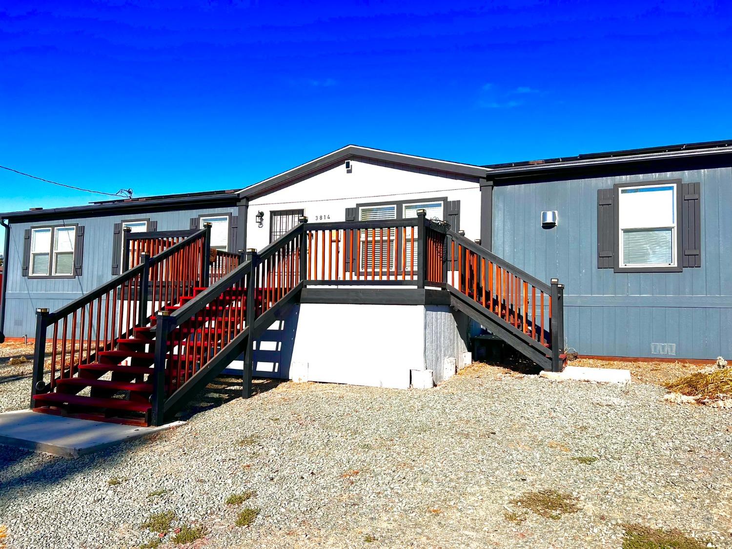 a view of a house with wooden deck