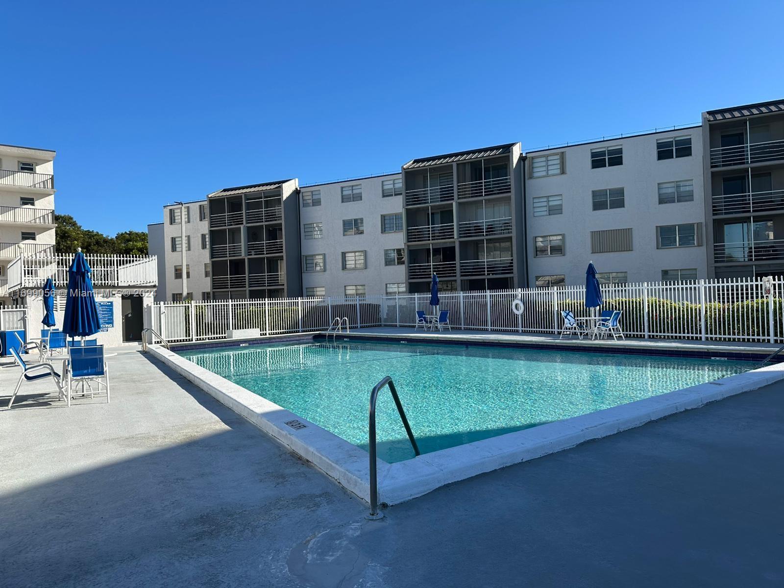 a view of tall building with a swimming pool